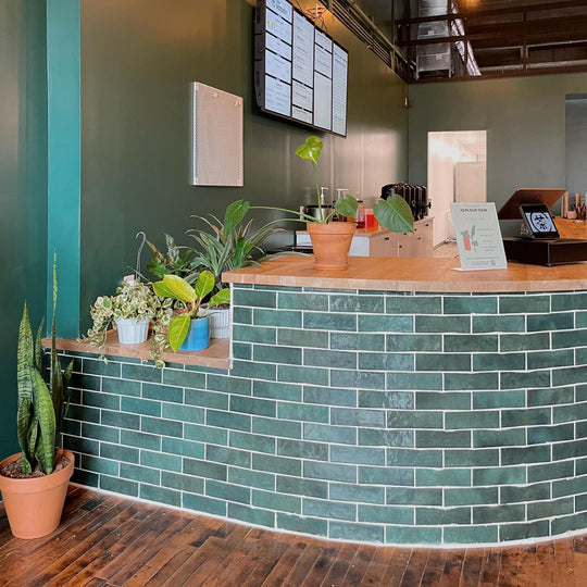 Cha Community Downtown Temple Shop photo of the front green tile bar with plants