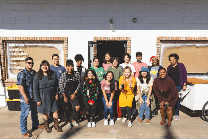 Group photo of all the small business vendors at the 2023 BIPOC Holiday Market in front of Cha Community Waco shop